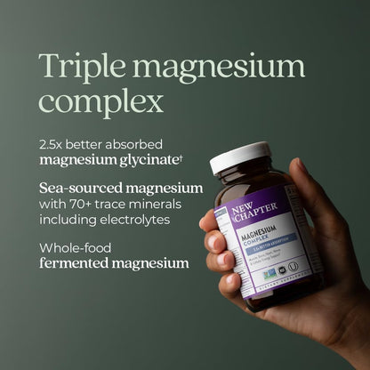 Hand holding a bottle of New Chapter magnesium supplement with product details on a dark green background