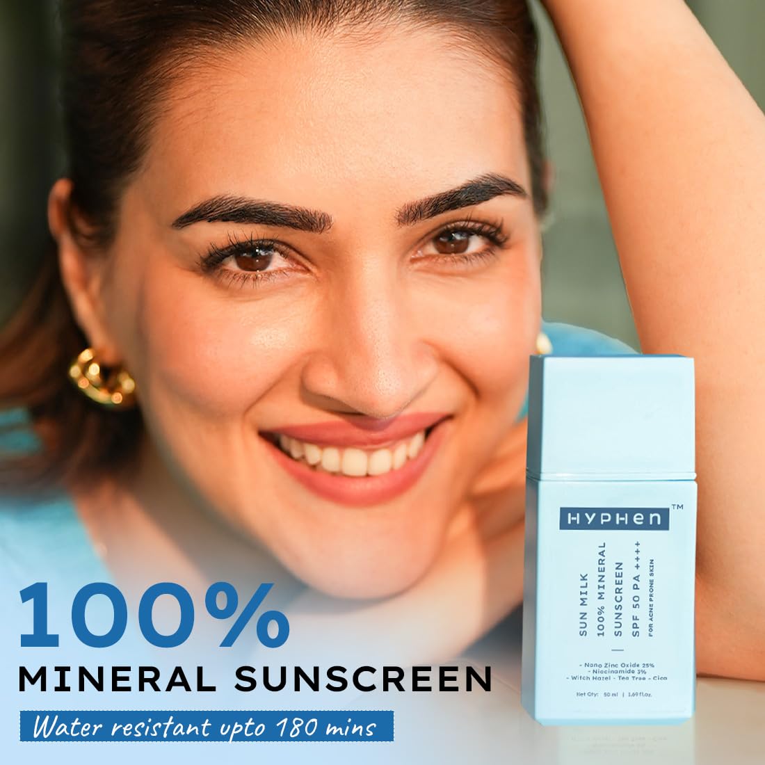 Woman with a smile next to a bottle of Hyphen sunscreen
