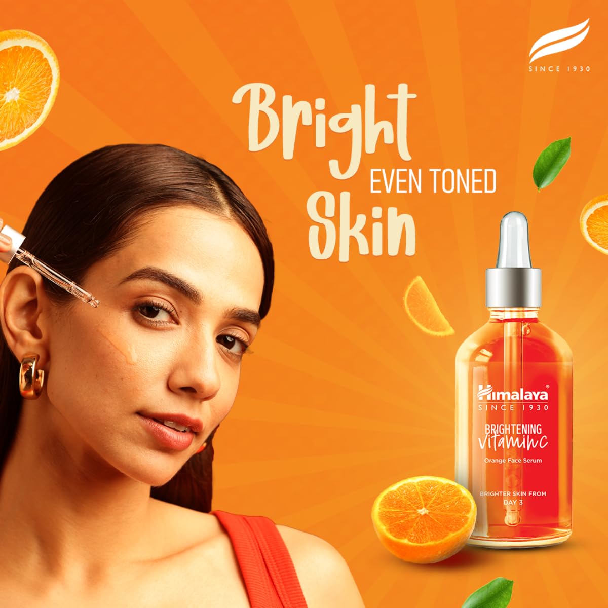 Woman with a skincare product on an orange background with oranges and leaves.