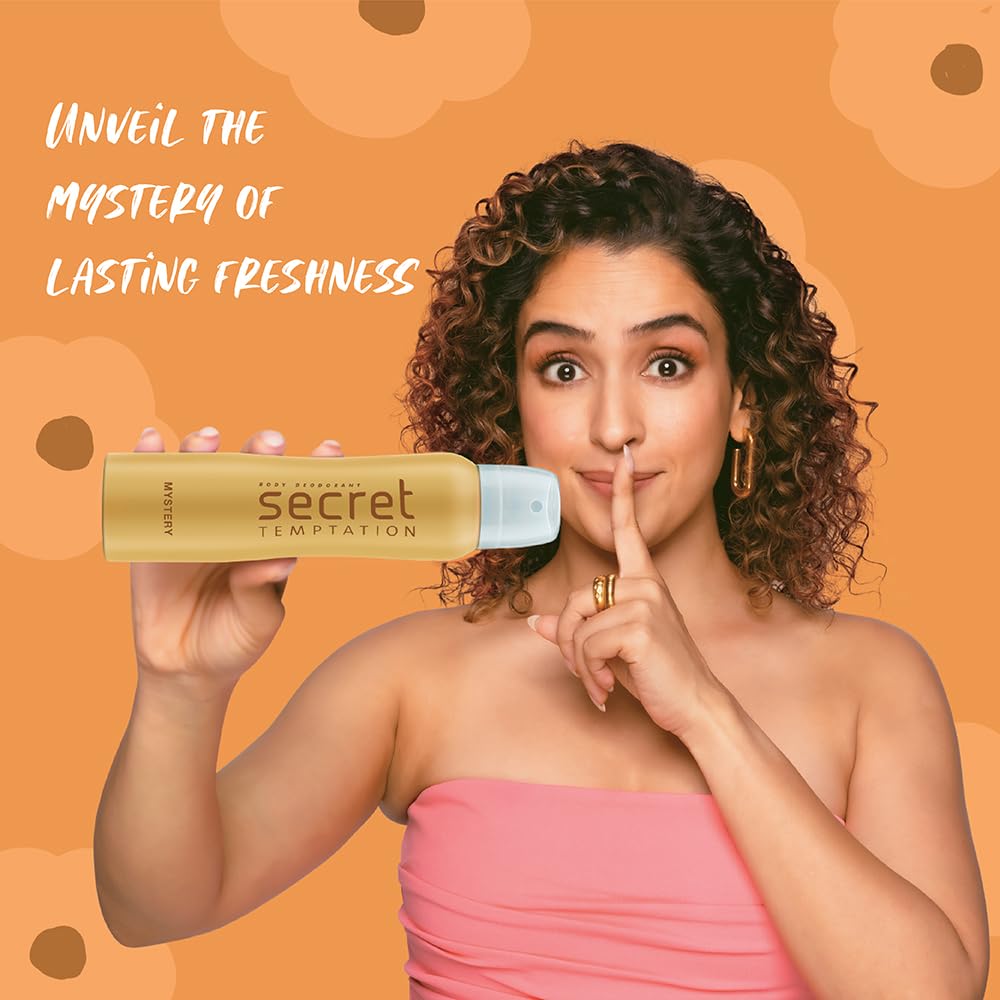 Woman holding a Secret Temptation product with an orange background