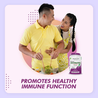 Couple cooking together with a supplement bottle on a light purple background