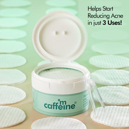 Caffeine-based skincare product with cotton pads on a light green background