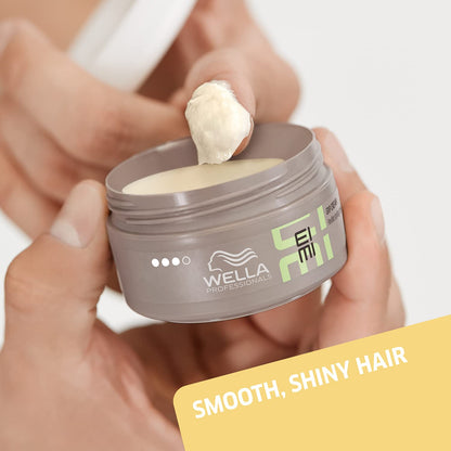 Wella Eimi hair product jar with cream being applied, on a neutral background