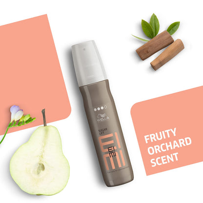Wella EIMI hair product with pear, cinnamon sticks, and leaves on a white background