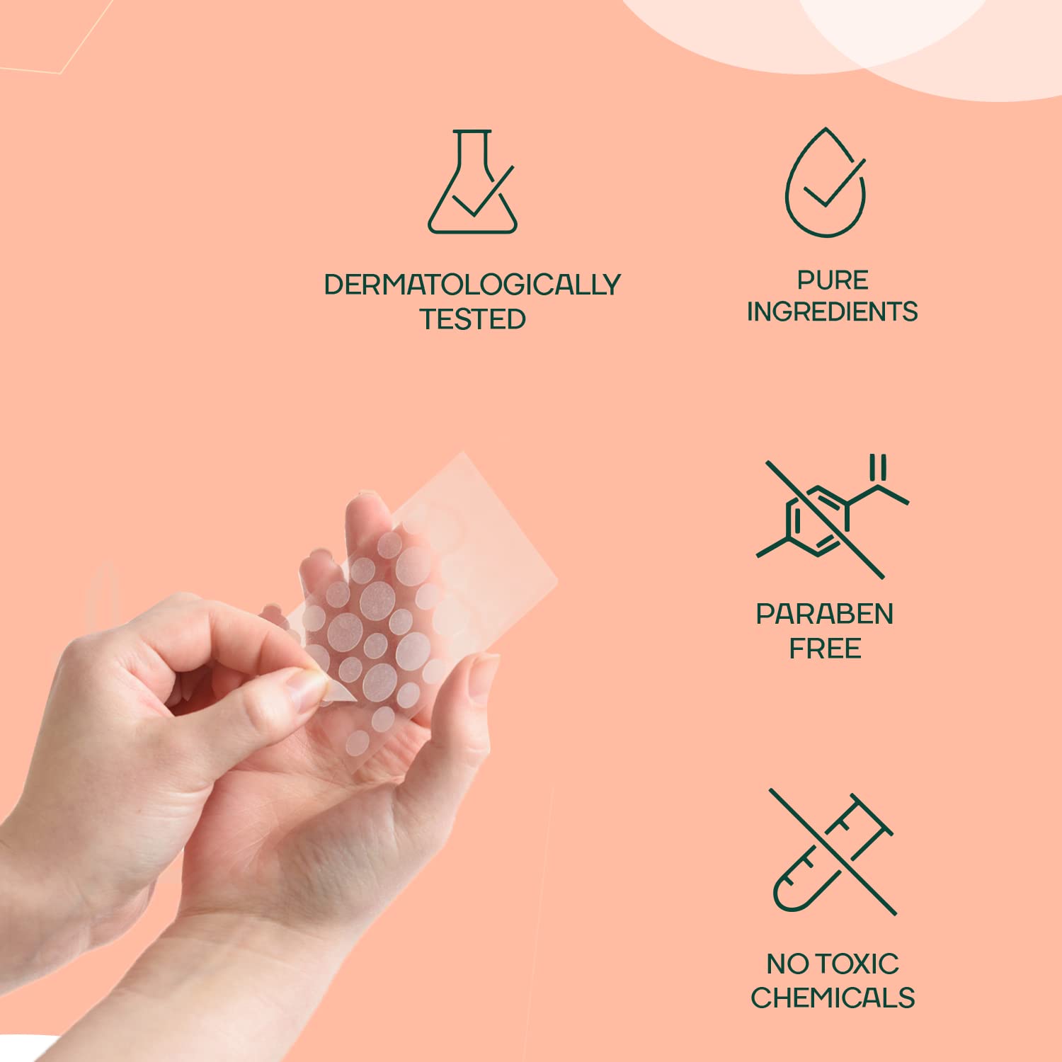 Hand holding a sheet of clear patches with dermatological and purity icons on a peach background