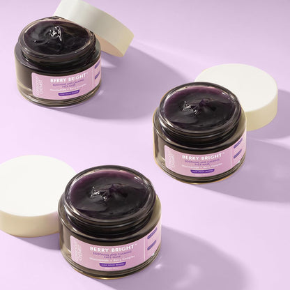 Three jars of 'Berry Bright' cream on a light purple background