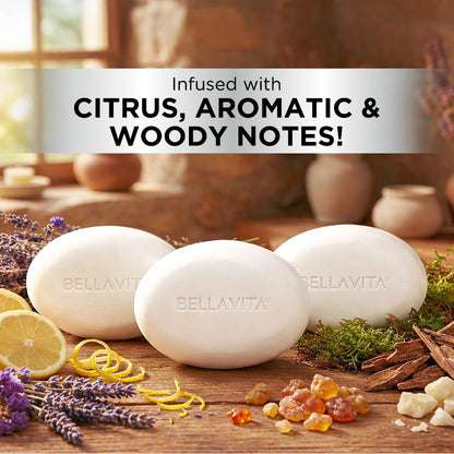 Three white BellaVita soap bars on a wooden surface with citrus, aromatic, and woody notes text above.