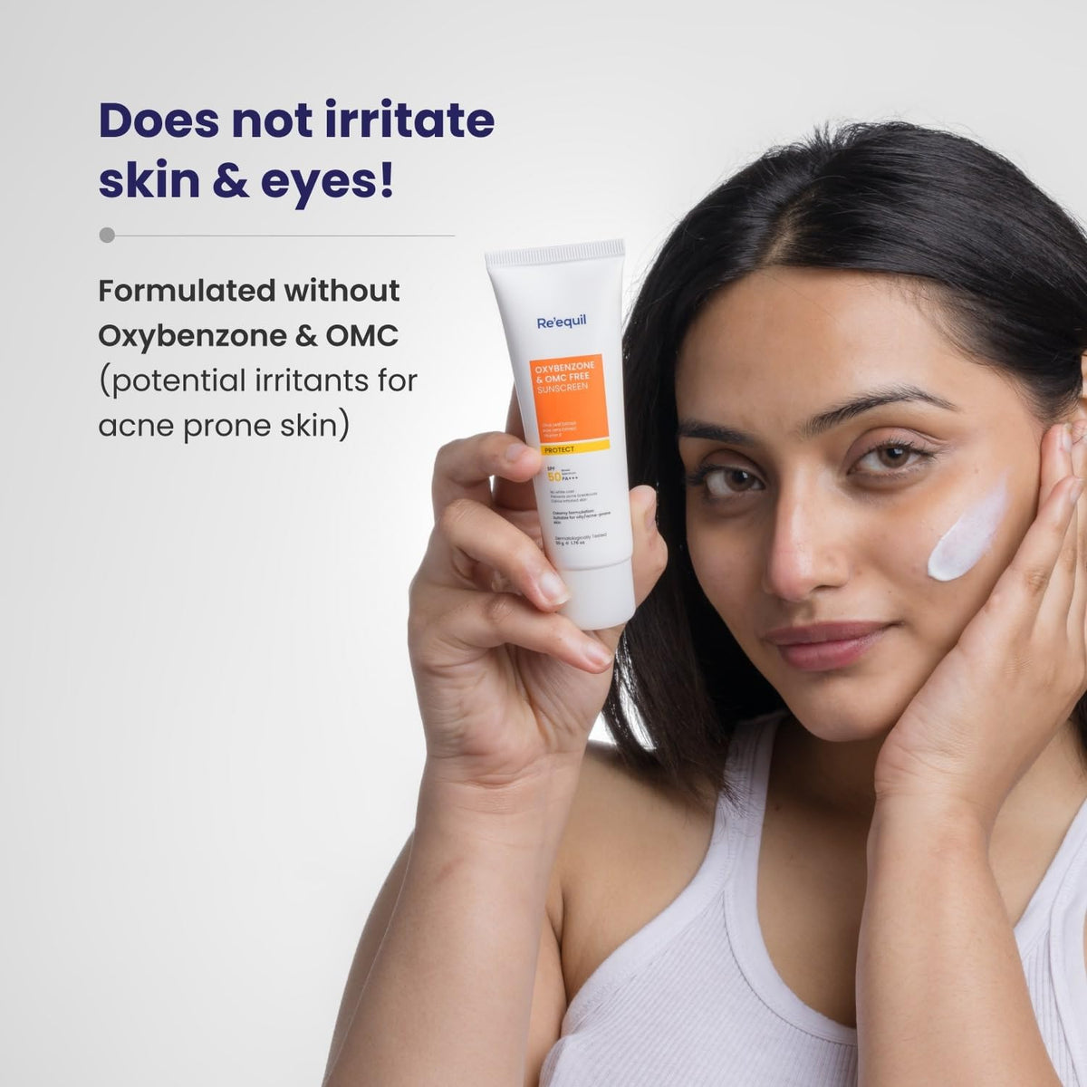Woman holding a skincare product with text about irritation and ingredient formulation.