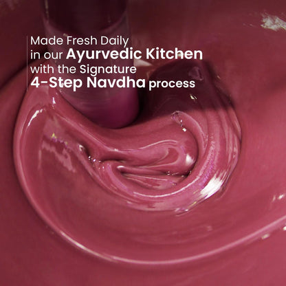 Close-up of a swirling pinkish-brown substance with text about Ayurvedic kitchen processes.