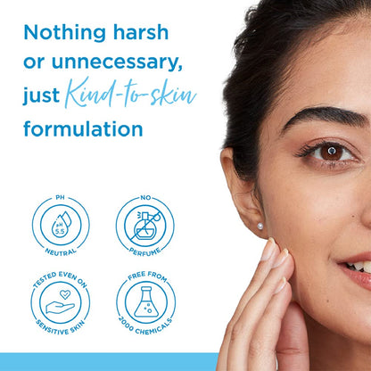 Woman touching her face with a focus on skin care formulation details.