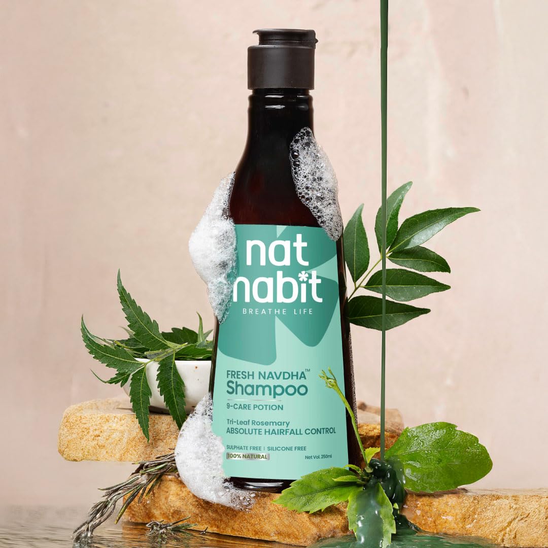 Bottle of nat nabit Fresh Navdha Shampoo with green label on a beige background