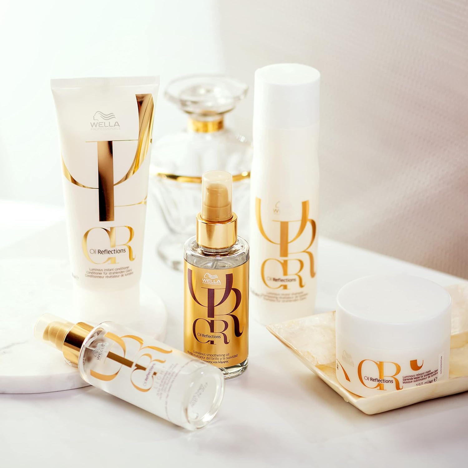 Wella Reflections hair care products on a white surface with a neutral background