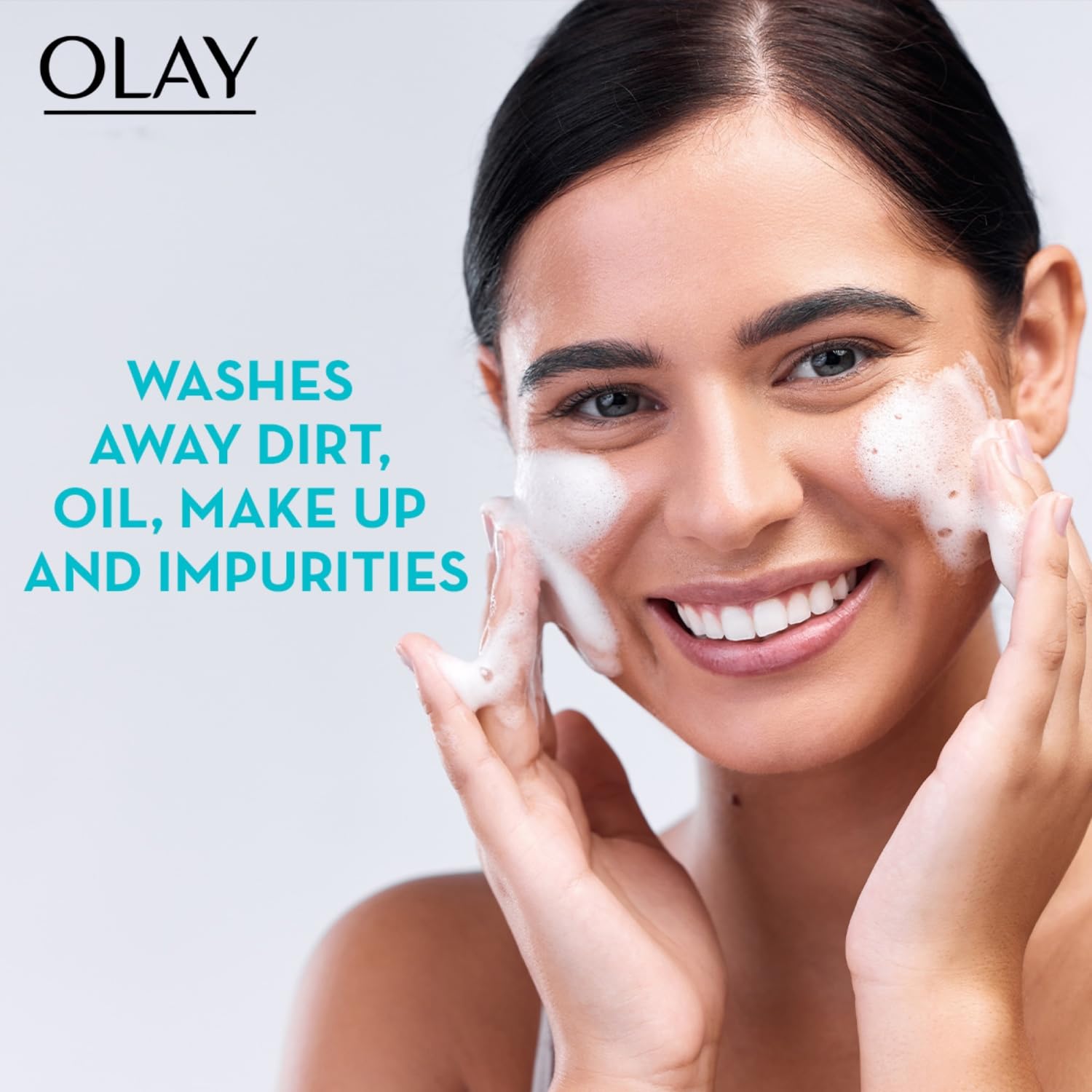 Woman applying Olay facial cleanser with text highlighting product benefits on a light gray background