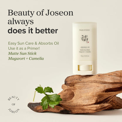 Beauty of Joseon Matte Sun Stick with mugwort and camellia on a wooden surface