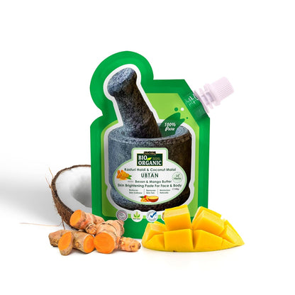 Green organic product packaging with coconut, turmeric, and mango on a white background