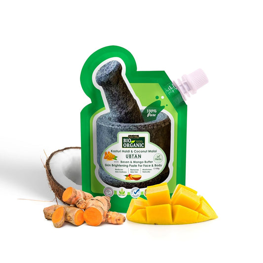 Green organic product packaging with coconut, turmeric, and mango on a white background