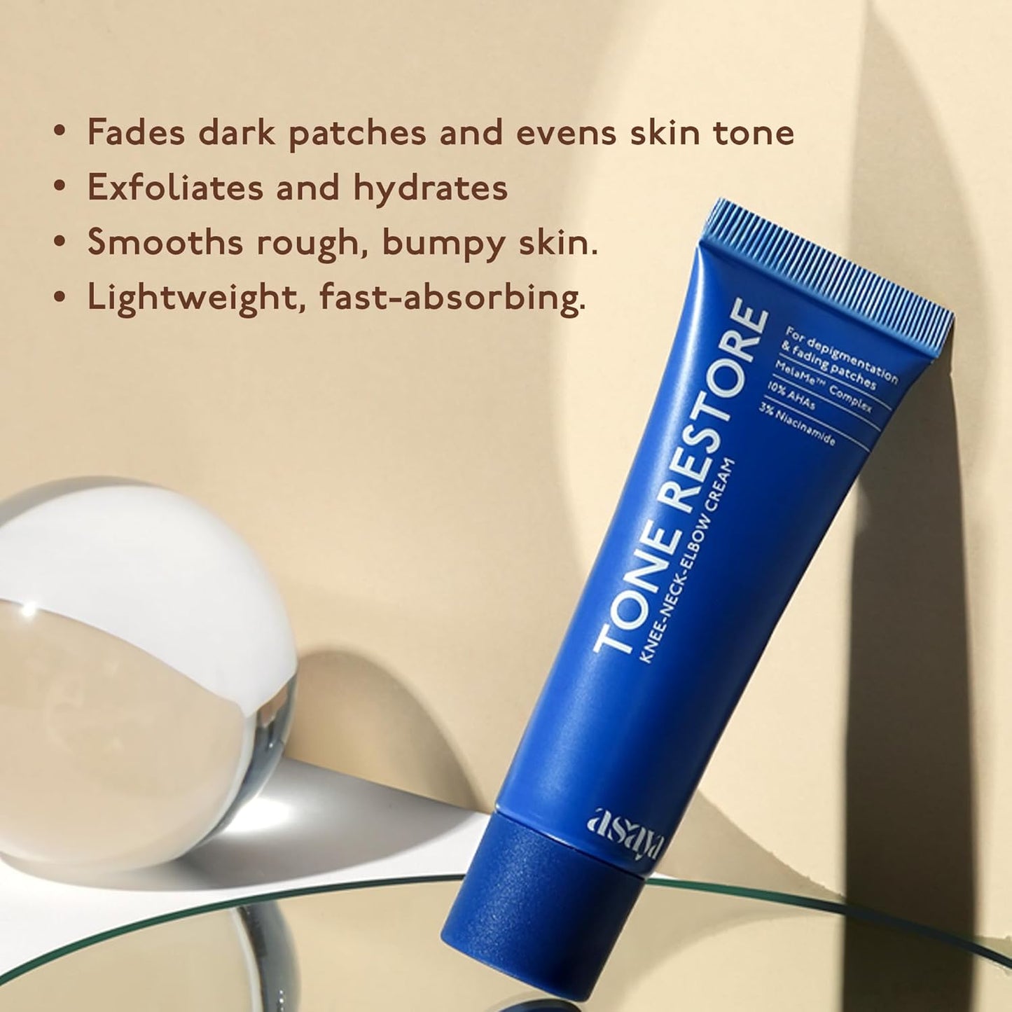 Blue tube of Tone Restore cream with text on a beige background