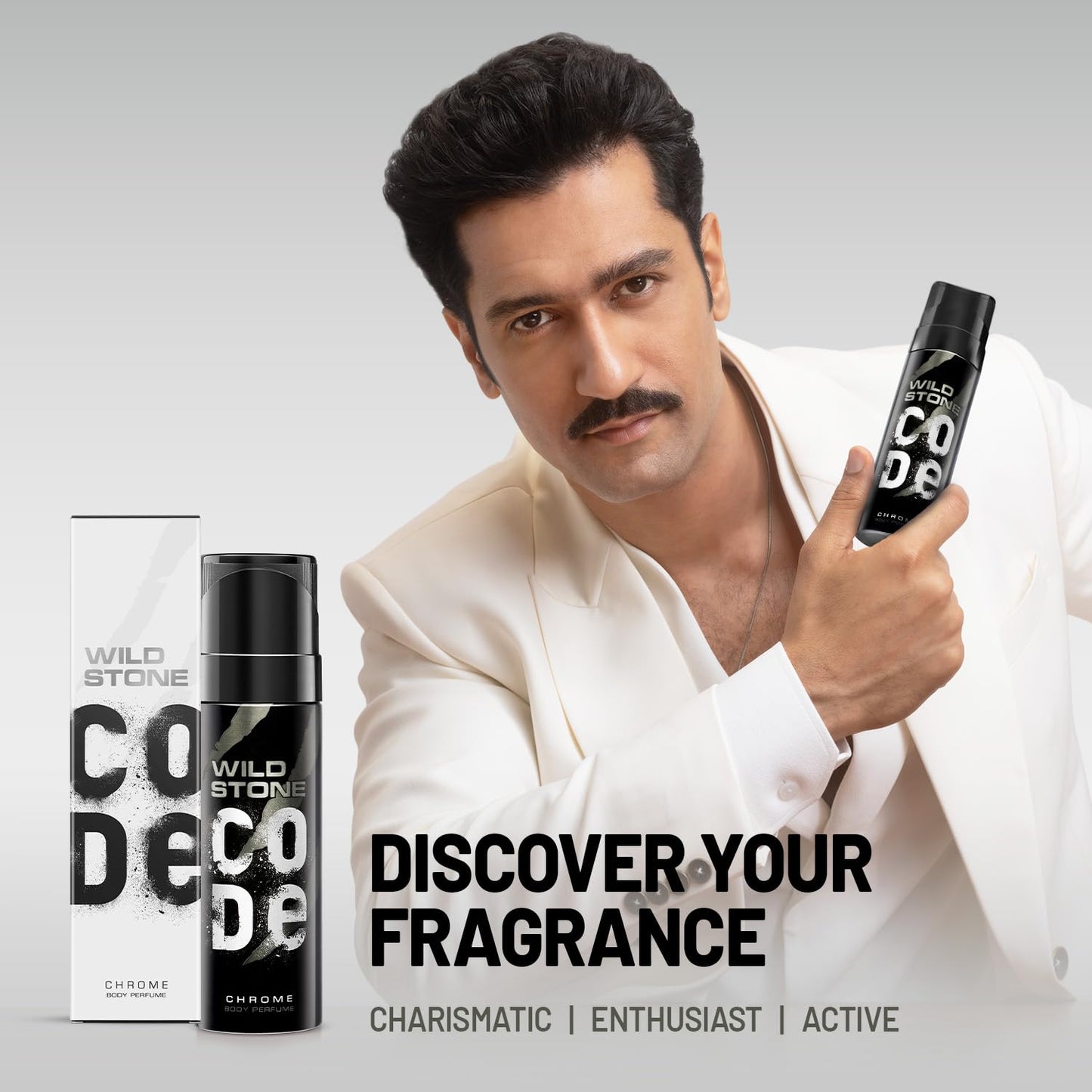 Man holding a Wild Stone deodorant can with product packaging on a gray background