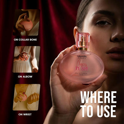 Person holding a pink perfume bottle with usage instructions on a dark background