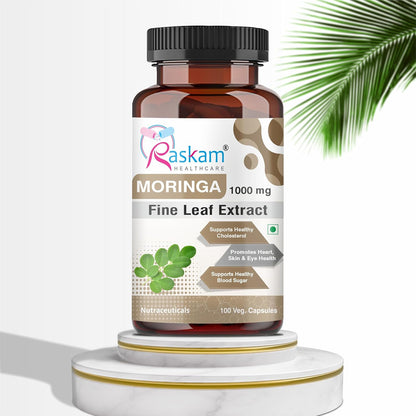Bottle of Raskam Moringa Fine Leaf Extract on a white background with a palm leaf.