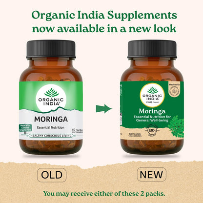 Two bottles of Organic India Moringa supplements with labels for old and new packaging on a beige background.