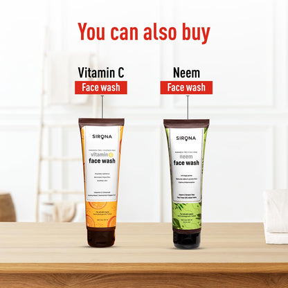 Two bottles of Sirona face wash, one labeled 'Vitamin C' and the other 'Neem', on a wooden surface with a white curtain background.