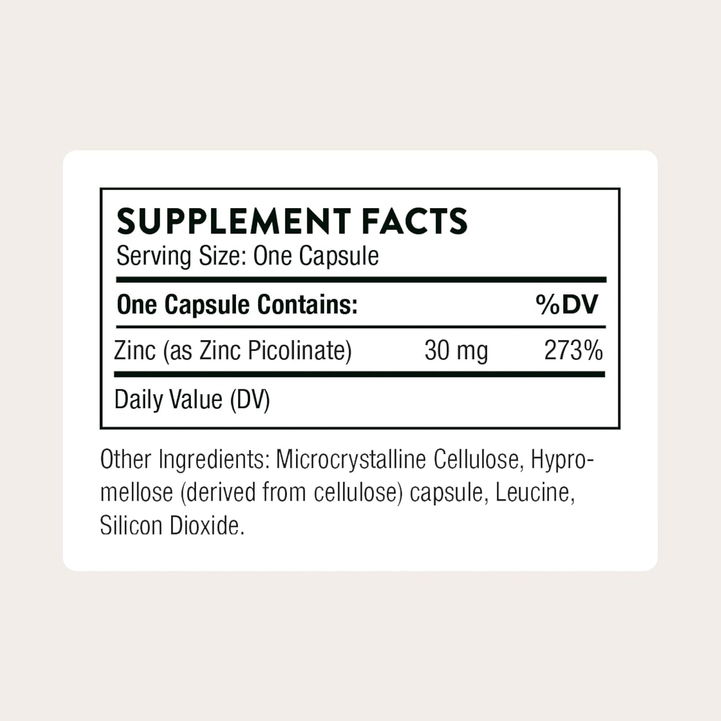 Supplement facts label for a zinc supplement capsule on a light beige background