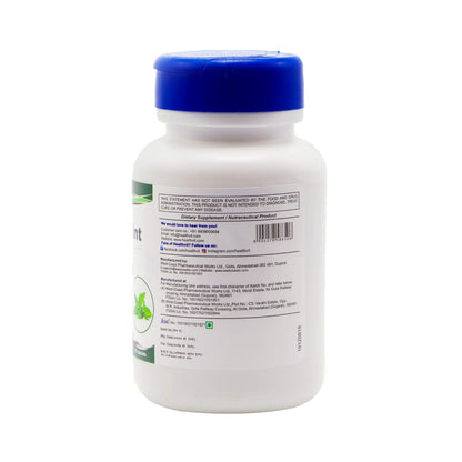 White supplement bottle with blue cap on a white background