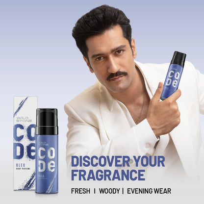 Man holding a Wild Stone Code perfume bottle with packaging on a light blue background