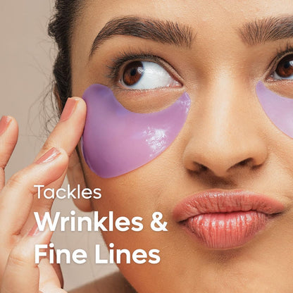 Woman applying purple eye mask with text 'Tackles Wrinkles & Fine Lines' on a neutral background