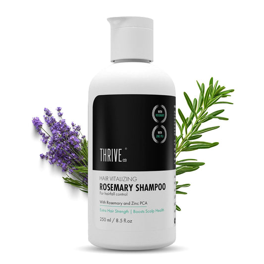 Thrive rosemary shampoo bottle with lavender and rosemary leaves on a white background