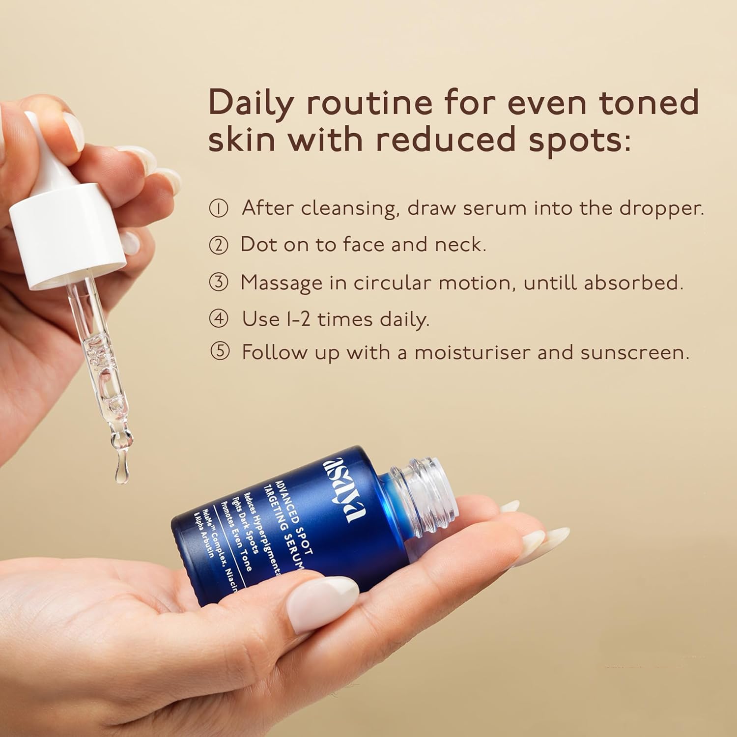 Hand holding a blue serum bottle with a dropper, against a beige background.