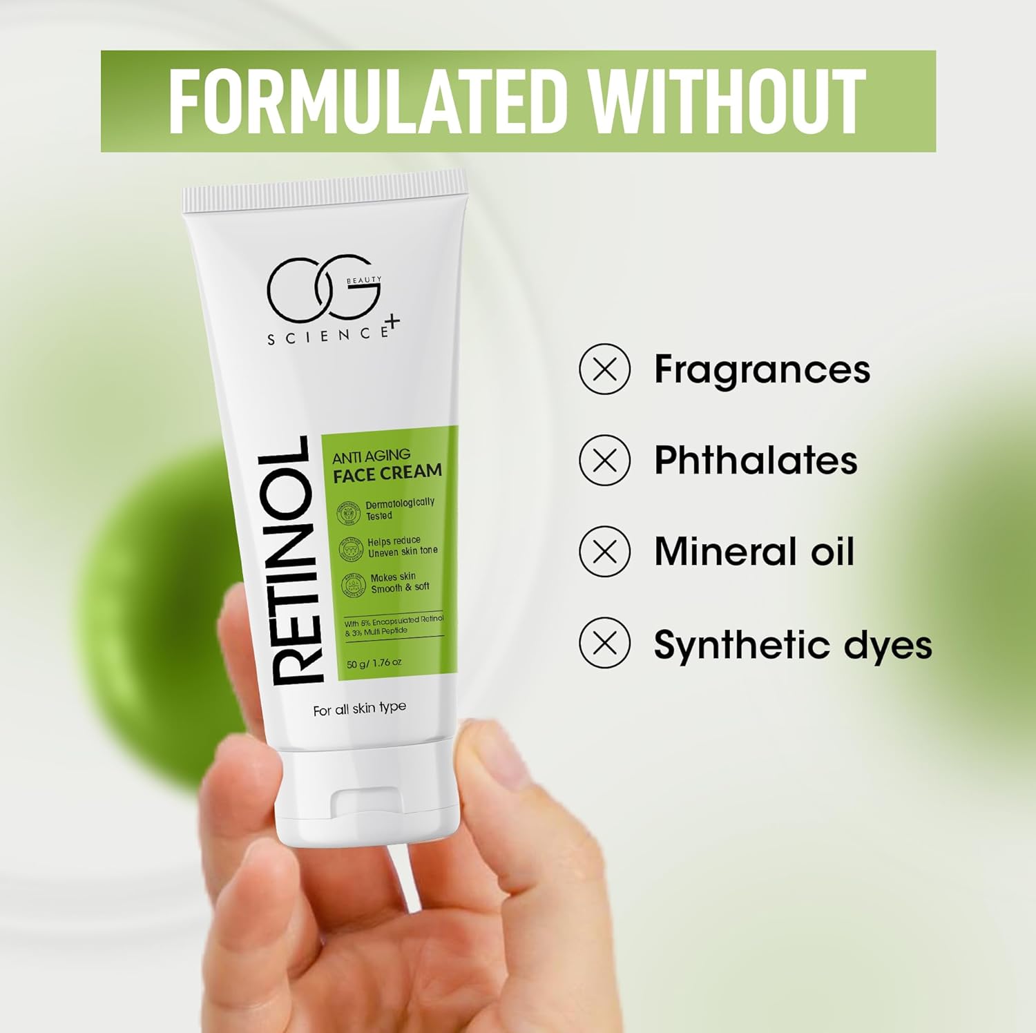 Tube of OG Science Retinol Anti-Aging Face Cream held by a hand with a green background.