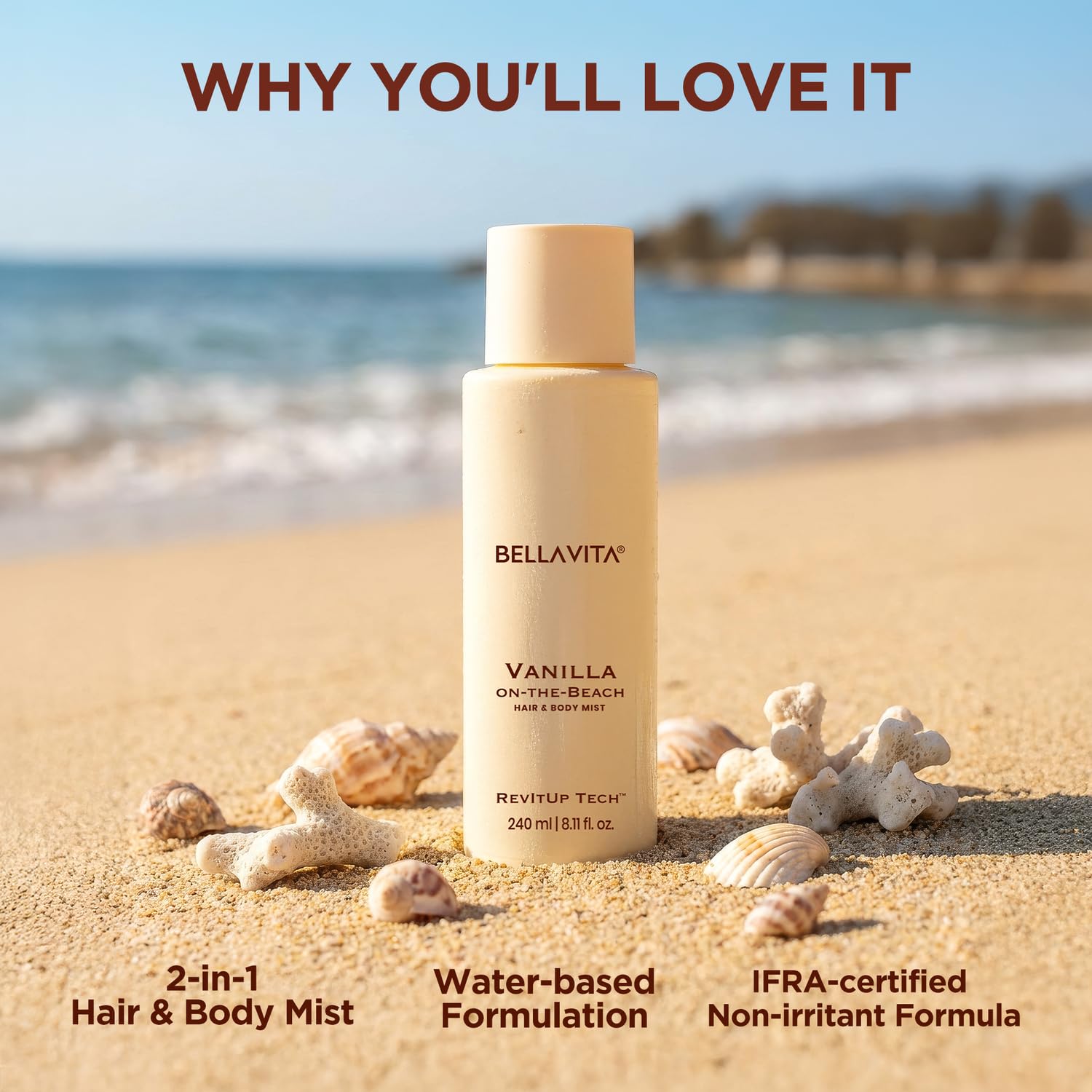 Bellavita Vanilla on-the-Beach hair and body mist bottle on a sandy beach with ocean view.