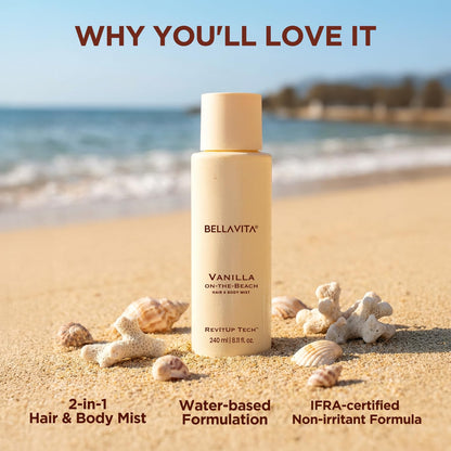 Bellavita Vanilla on-the-Beach hair and body mist bottle on a sandy beach with ocean view.