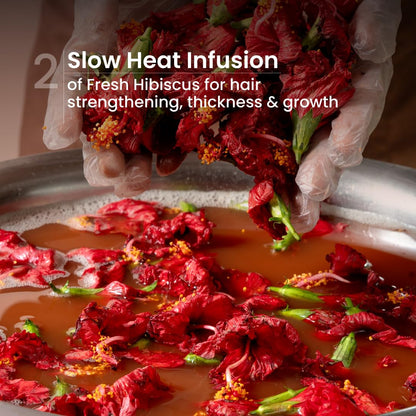 Red hibiscus flowers being infused in a pot with text about slow heat infusion for hair benefits.
