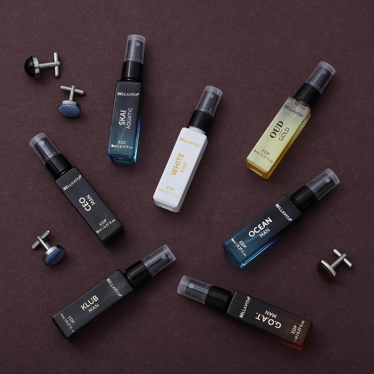 Collection of men's cologne bottles and cufflinks on a brown background