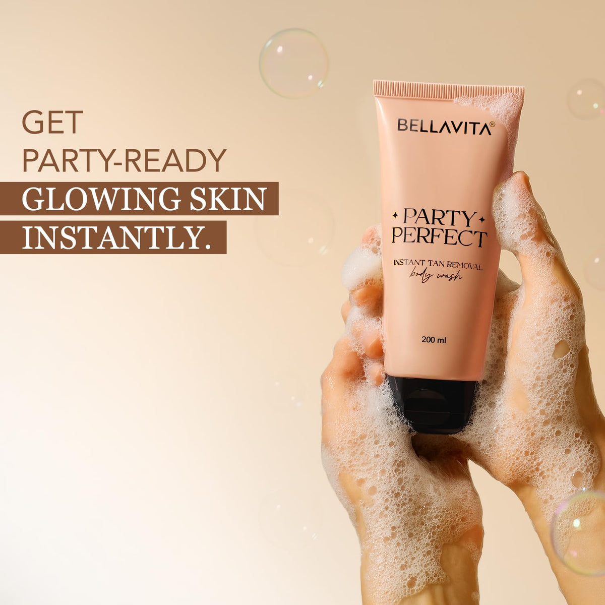 Hand holding a tube of Bellavita 'Party Perfect' body wash with text on a beige background