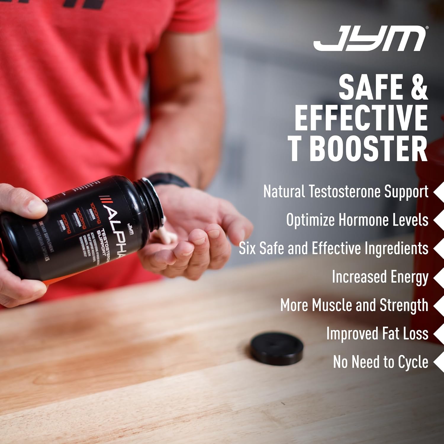 Person holding a supplement bottle with JYM Safe & Effective T Booster text and product features listed.