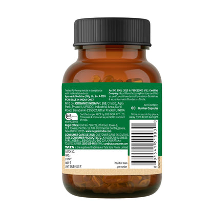 Brown supplement bottle with green label on a white background