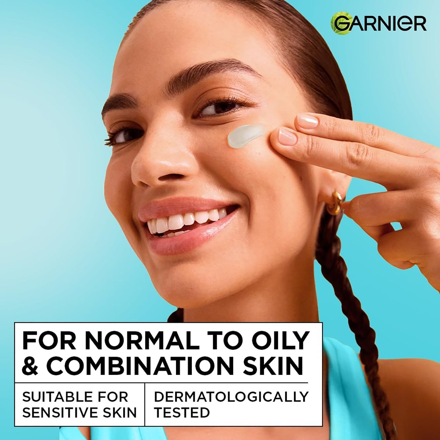 Woman applying skincare product on her face with Garnier branding