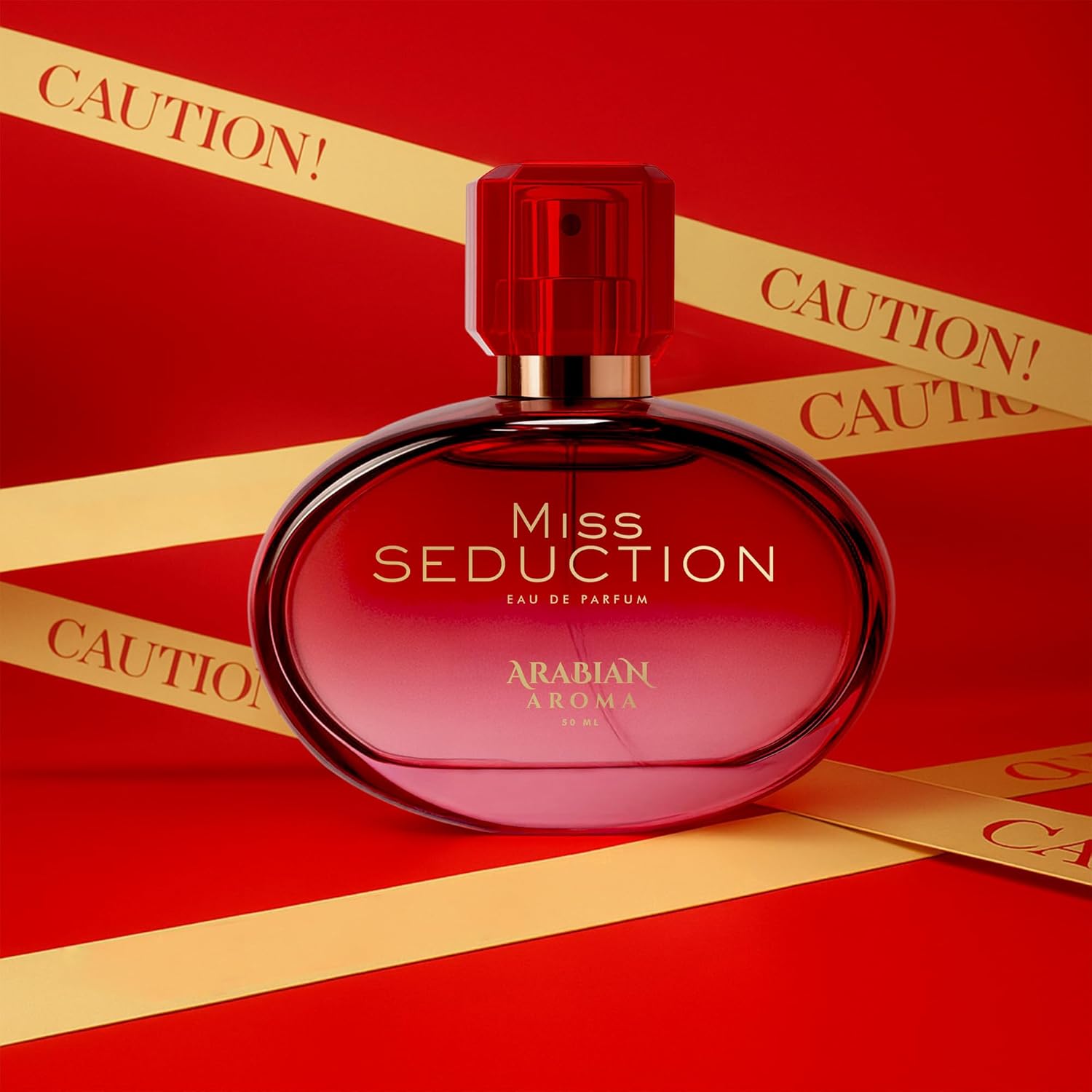 Red 'Miss Seduction' perfume bottle with gold ribbons on a red background
