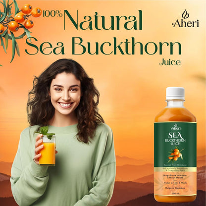 Woman holding a glass of sea buckthorn juice with a bottle of Aheri sea buckthorn juice on an orange background.