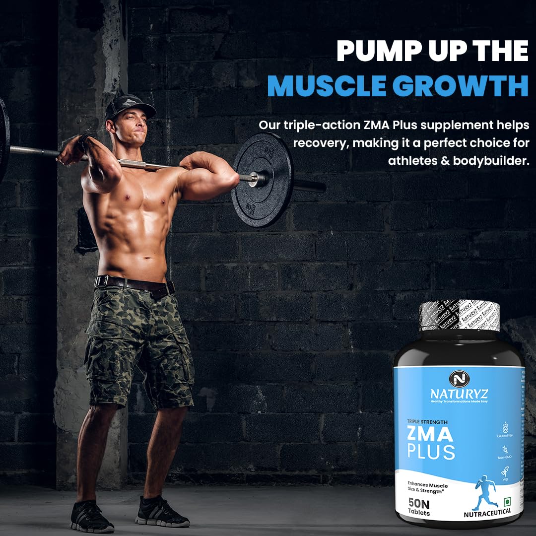 Man lifting weights with a supplement bottle labeled 'Naturyz ZMA Plus' on a dark brick wall background.