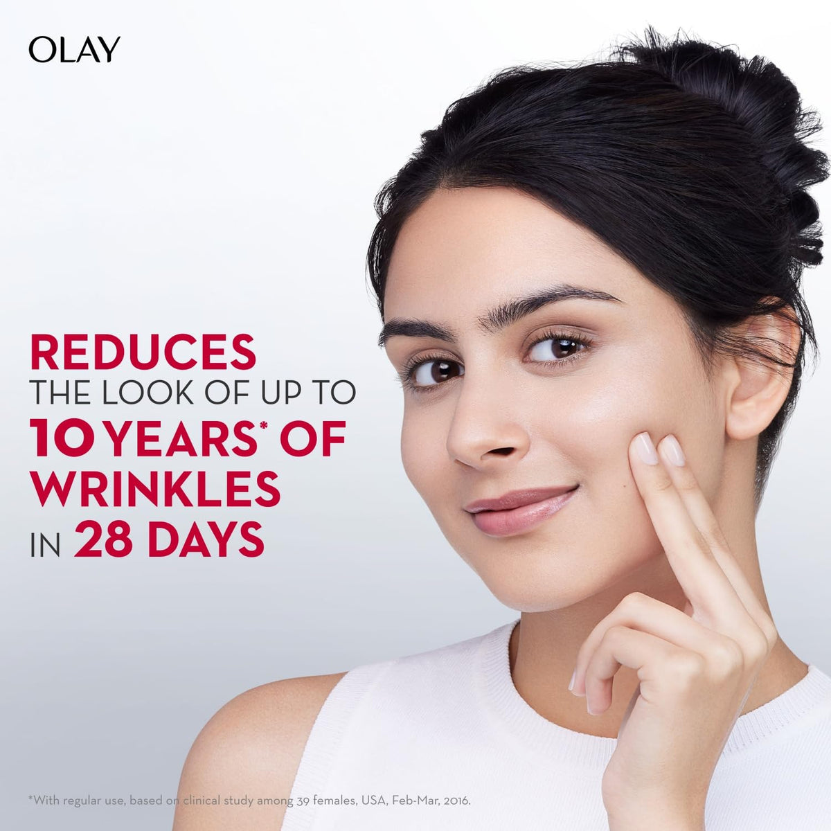 Olay advertisement with a woman touching her face, highlighting wrinkle reduction benefits.