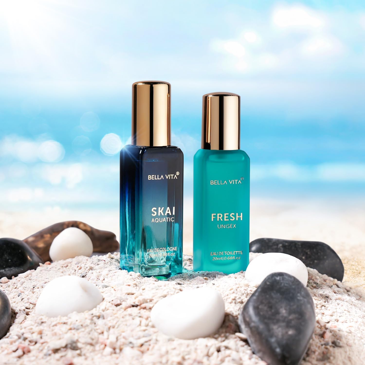 Two Bella Vita perfume bottles on a beach with a blue sky background