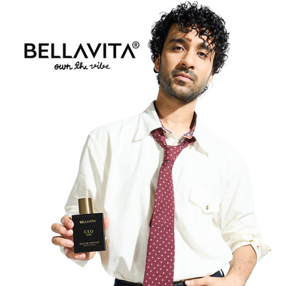 Man holding a Bellavita perfume bottle with a white background