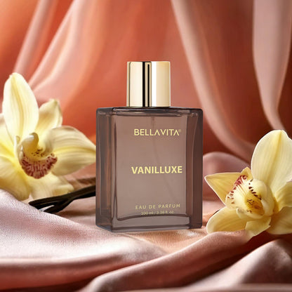 BellaVita Vanilluxe perfume bottle with flowers on a soft fabric background