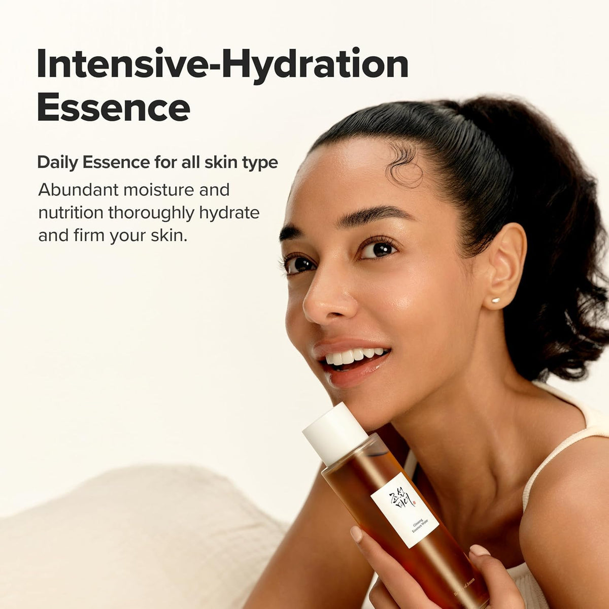 Woman holding a bottle of Intensive-Hydration Essence with product description text.