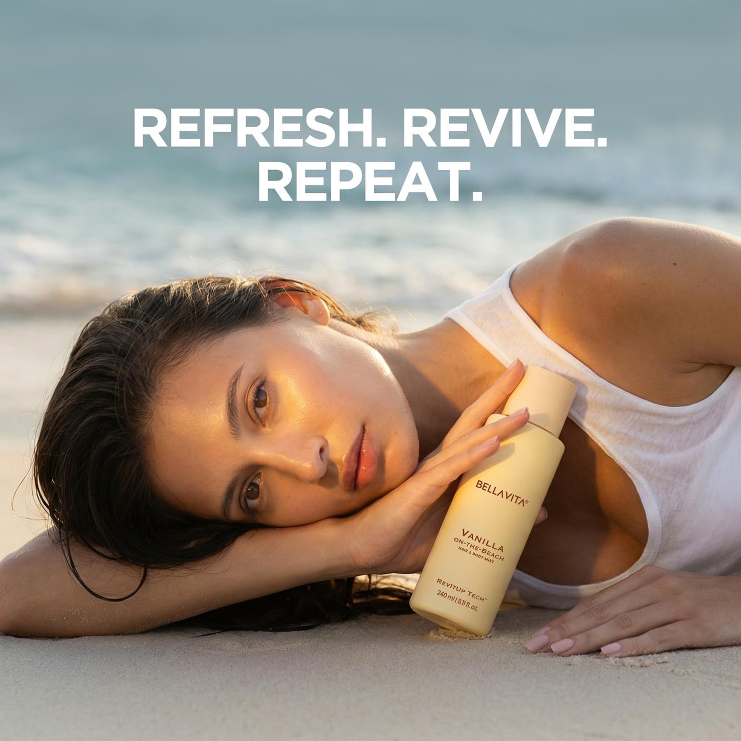 Woman lying on a beach holding a vanilla scented bottle with 'Refresh. Revive. Repeat.' text above.